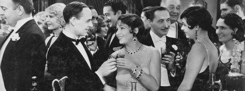 A lively 1920s party scene with elegantly dressed men and women enjoying drinks and socializing.