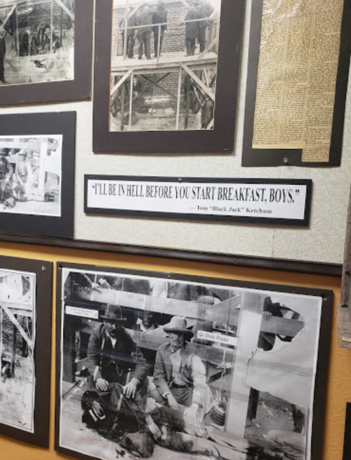 Historical display featuring black-and-white photos and a quote by "Black Jack" Ketchum about breakfast.