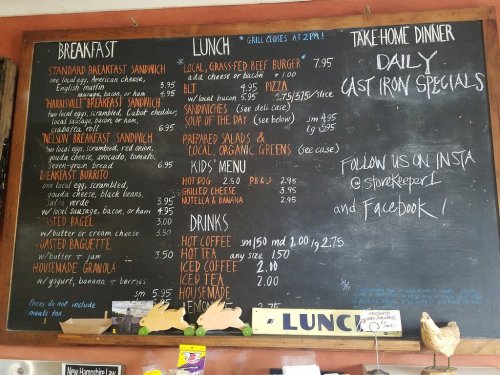 Chalkboard menu displaying breakfast, lunch, dinner specials, and drinks with prices at a casual dining establishment.