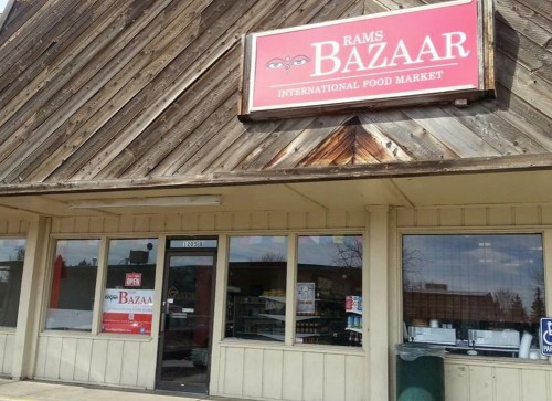 Exterior of Rams Bazaar, an international food market, featuring a wooden facade and a prominent sign.
