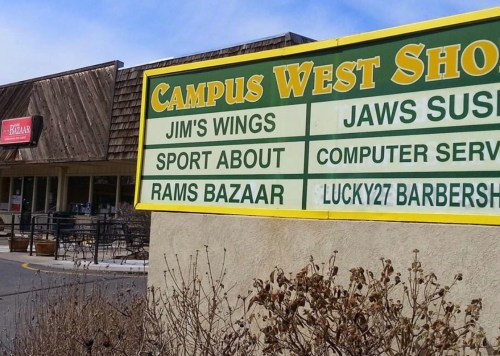 Sign for Campus West Shops listing various businesses, including Jim's Wings, Jaws Sushi, and Rams Bazaar.