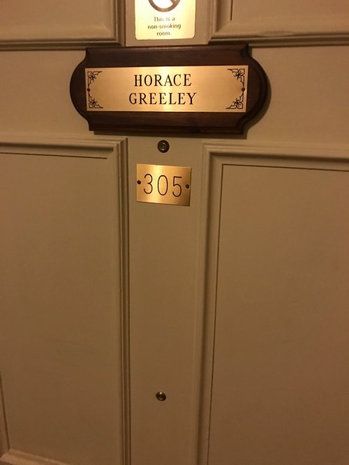 Door with a nameplate reading "Horace Greeley" and the room number "305" displayed below.