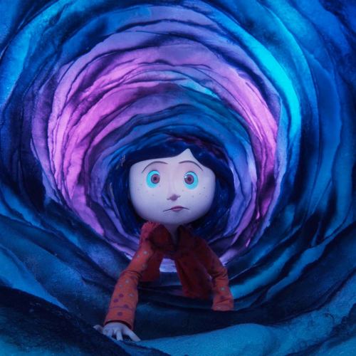 A young girl with dark hair and a red outfit explores a colorful, swirling tunnel.