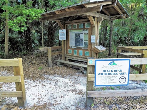 Information kiosk at the entrance of Black Bear Wilderness Area, surrounded by trees and natural scenery.