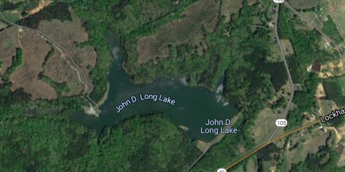 Aerial view of John D. Long Lake surrounded by green forests and roads.