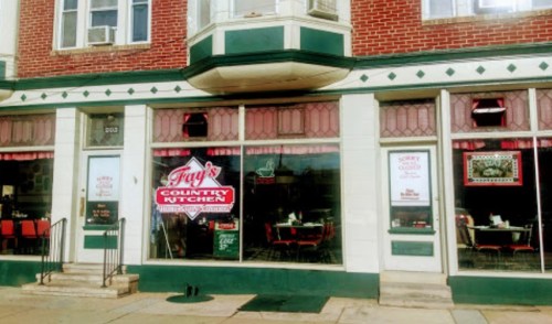 Exterior of Fray's Country Kitchen, featuring large windows, red and green decor, and a welcoming entrance.