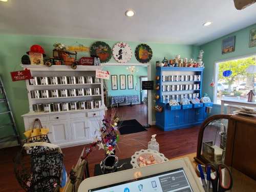 A cozy shop interior with colorful shelves, decorative items, and a welcoming atmosphere.