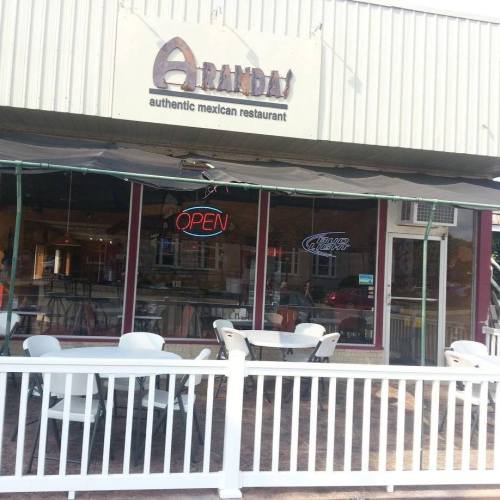 Exterior of Aranda's, an authentic Mexican restaurant, featuring an "Open" sign and outdoor seating.