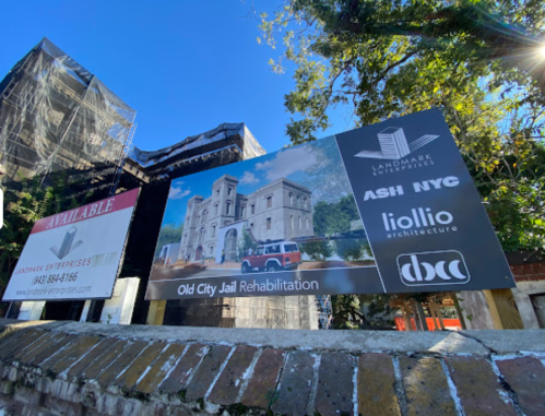 Sign for Old City Jail Rehabilitation project featuring logos of Ash NYC, Liollio Architecture, and Landmark Enterprises.