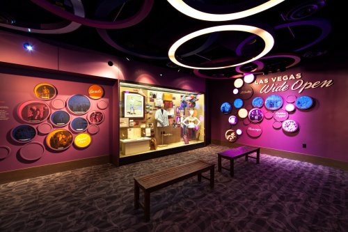 A colorful exhibit in Las Vegas featuring displays and a person interacting with the installation.