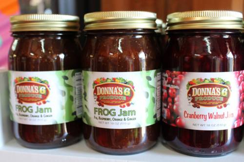 Three jars of jam on a shelf: FROG Jam (fig, raspberry, orange, ginger) and Cranberry Walnut Jam.