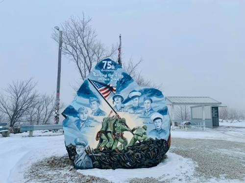A painted monument commemorating the 75th anniversary of Raising the Flag on Iwo Jima, featuring soldiers and an American flag.
