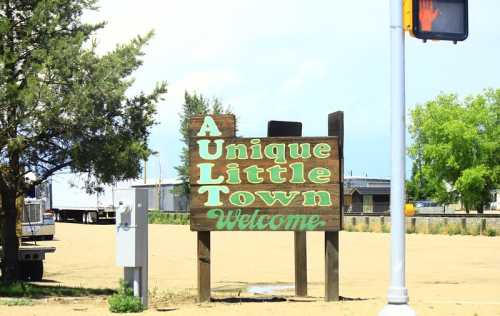 Welcome sign for Ault, a unique little town, with trees and a clear sky in the background.