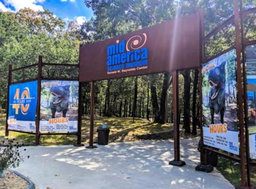 Entrance to Mid-America Science Museum, featuring banners celebrating 40 years and hours of operation.