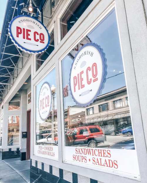 Exterior of Snohomish Pie Co. featuring large windows with menu items: pies, cookies, sandwiches, soups, and salads.