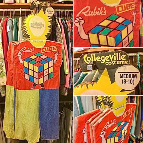 A colorful Rubik's Cube costume displayed on a rack, labeled as a Collegeville costume in size medium (8-10).