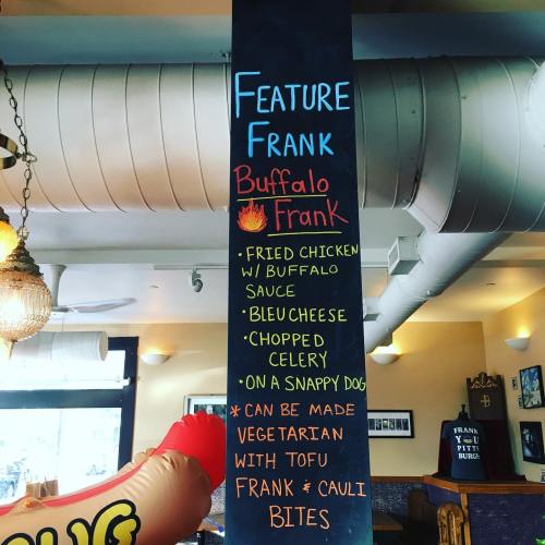 Chalkboard menu featuring "Buffalo Frank" with fried chicken, buffalo sauce, and options for tofu and cauliflower bites.