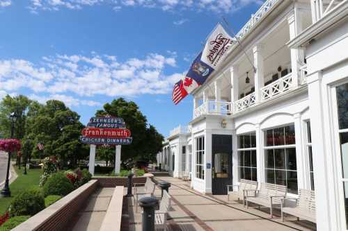 Exterior view of Zehnder's restaurant in Frankenmuth, featuring flags and a sign for famous chicken dinners.