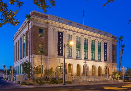 Exterior view of the Mob Museum at dusk, showcasing its historic architecture and illuminated signage.