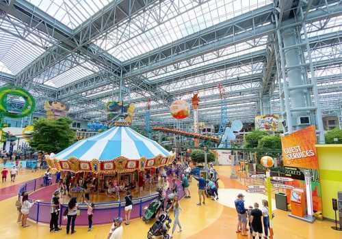 A vibrant indoor amusement park with a carousel, colorful decorations, and visitors enjoying the attractions.