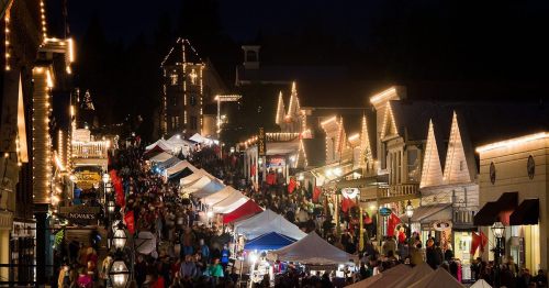 A bustling night market with colorful tents and festive lights, filled with crowds enjoying the vibrant atmosphere.