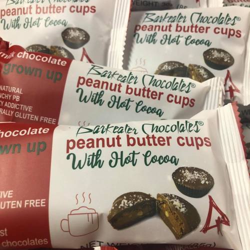 Packaging of Bark-eater Chocolate peanut butter cups with hot cocoa, featuring a red background and product details.