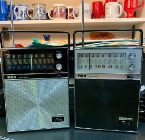 Two vintage RCA solid state radios with dials and antennas, one with a silver front and the other with a black front.