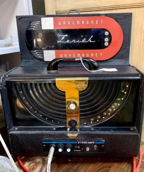 Vintage Zenith Wavemagnet radio with a black body and a red top, featuring dials and a speaker grill.