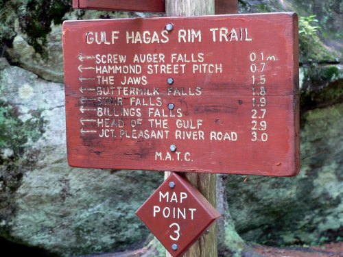 Wooden trail sign with directions and distances to various landmarks on the Gulf Hagas Rim Trail. Map point 3 indicated.