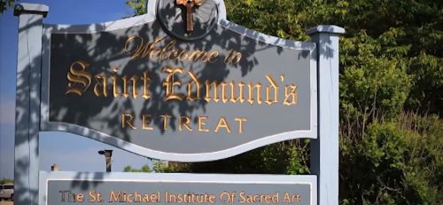 Sign welcoming visitors to Saint Edmund's Retreat, featuring the St. Michael Institute of Sacred Art.