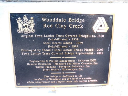 Plaque detailing the history and renovations of Wooddale Bridge, including dates and project management information.