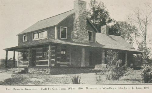 Historic log cabin house with a stone chimney, labeled as the first house in Knoxville, built in 1786.