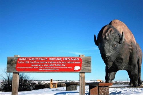 A large concrete buffalo sculpture with a sign reading "World's Largest Buffalo" in Jamestown, North Dakota.