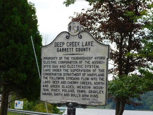 Historical marker for Deep Creek Lake in Garrett County, detailing its management and surrounding water streams.