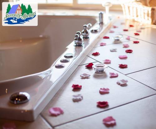 A luxurious bathtub adorned with rose petals and candles, creating a serene and inviting atmosphere.