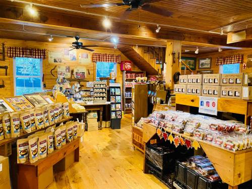 A cozy store interior with wooden decor, shelves filled with packaged goods, and a warm, inviting atmosphere.
