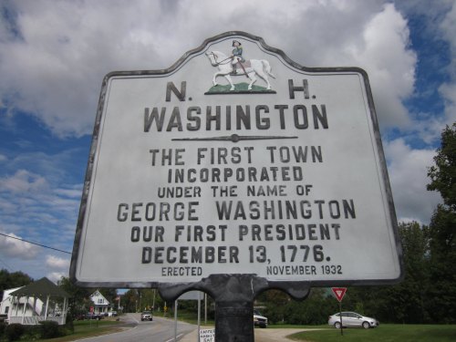 Sign for Washington, New Hampshire, noting it was the first town named after George Washington, established December 13, 1776.