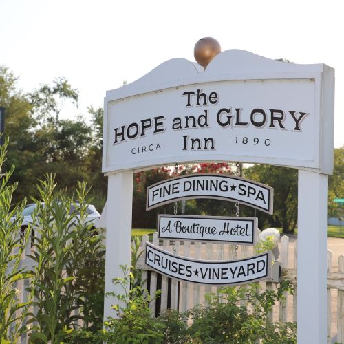 Sign for the Hope and Glory Inn, established in 1890, featuring fine dining, a spa, and boutique hotel services.