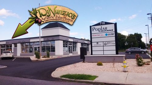 Sign for DJ Nunzio's Authentic Italian Hoagies, located at Poplar Commons, with a clear view of the building and parking lot.