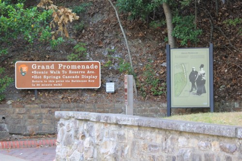Sign for the Grand Promenade, featuring a scenic walk and information about the Hot Springs Cascade Display.