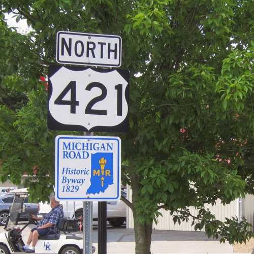 A road sign indicating North 421 and a historical marker for Michigan Road, established in 1829.