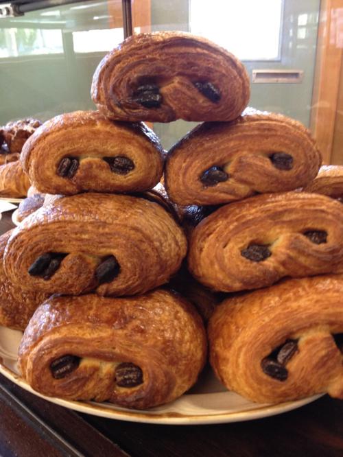 A stack of golden-brown pastries with chocolate filling, arranged neatly on a plate.