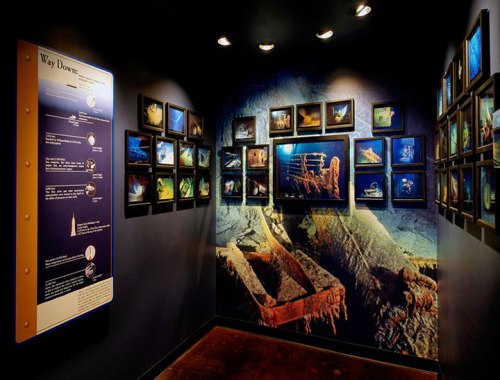 Exhibit room featuring underwater exploration photos and information about shipwrecks on the wall.