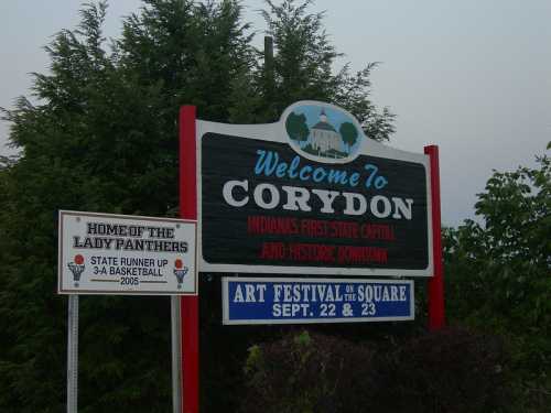 Welcome sign for Corydon, Indiana, highlighting its history as the first state capital and an upcoming art festival.