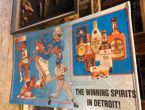 Vintage advertisement featuring sports figures and various whiskey brands, with the text "THE WINNING SPIRITS IN DETROIT!"