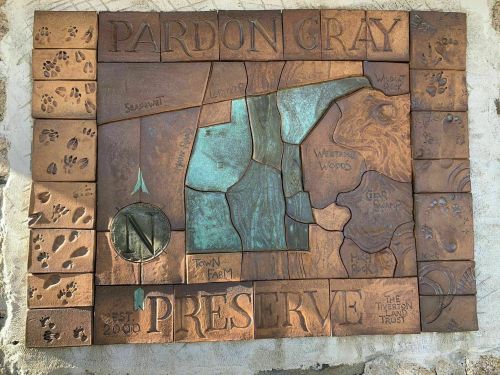 Bronze plaque map of Pardon Gray Preserve, featuring trails, landmarks, and a compass rose. Established 2010.