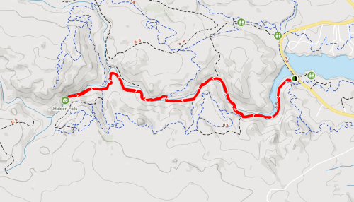 Map showing a winding red trail leading to Hidden Falls, surrounded by contour lines and nearby landmarks.