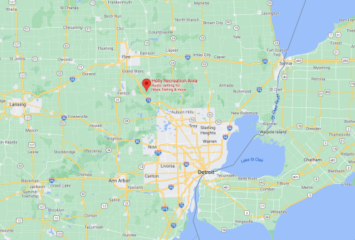 Map showing the Holly Recreation Area in Michigan, located northeast of Detroit, with surrounding towns and highways.