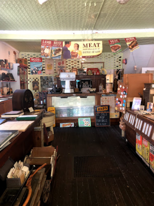 A vintage butcher shop interior with wooden counters, old signage, and various nostalgic decor items.
