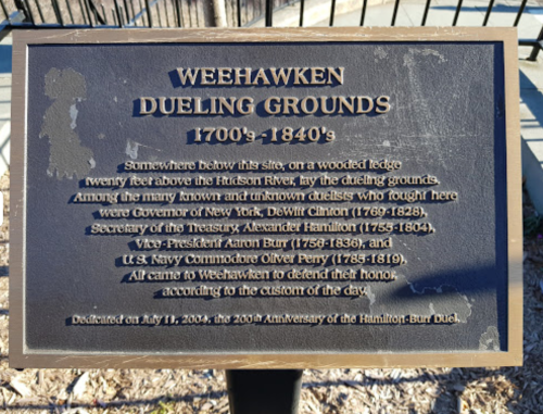 Plaque at Weehawken Dueling Grounds, detailing historical duels and notable figures involved, from 1700s to 1840s.